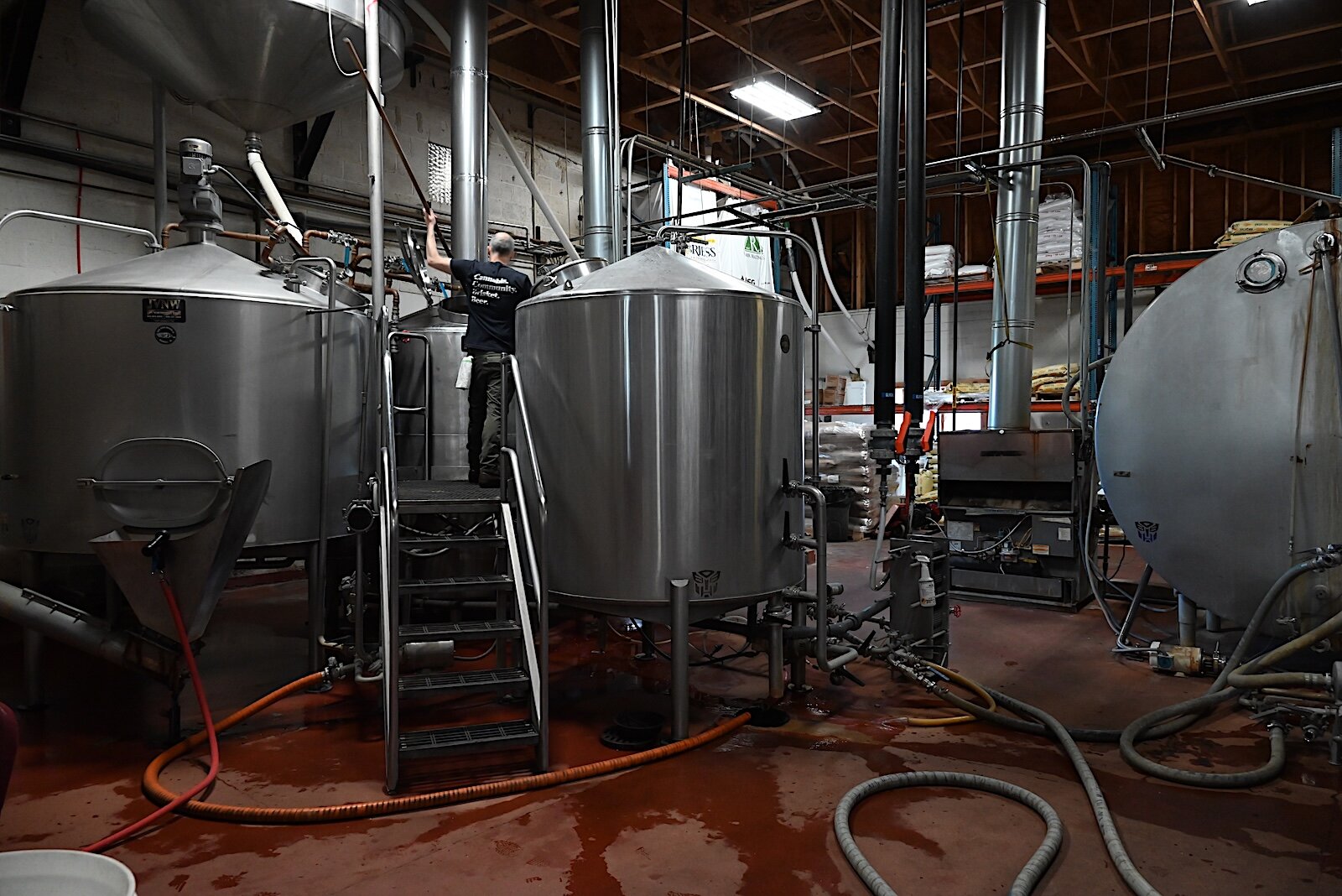 A brewer checks some of the tanks of beer being brewed at Dark Horse.