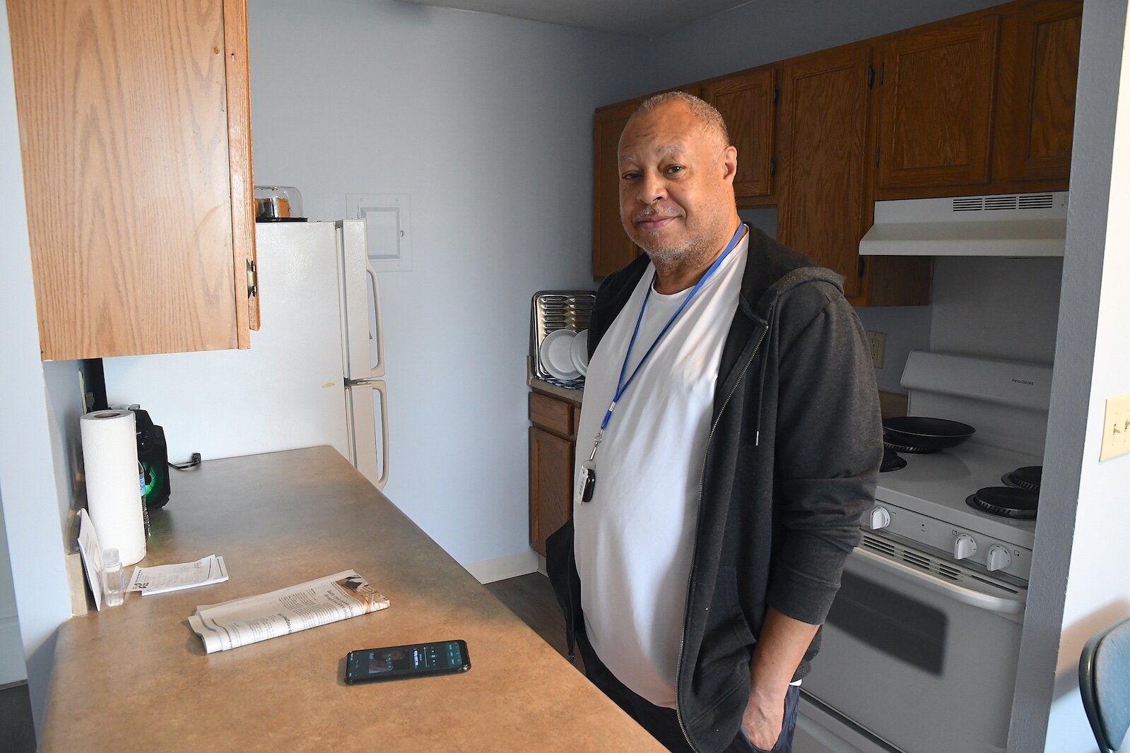 Lowell Wilson stands in the kitchen of his apartment. He loves to cook.