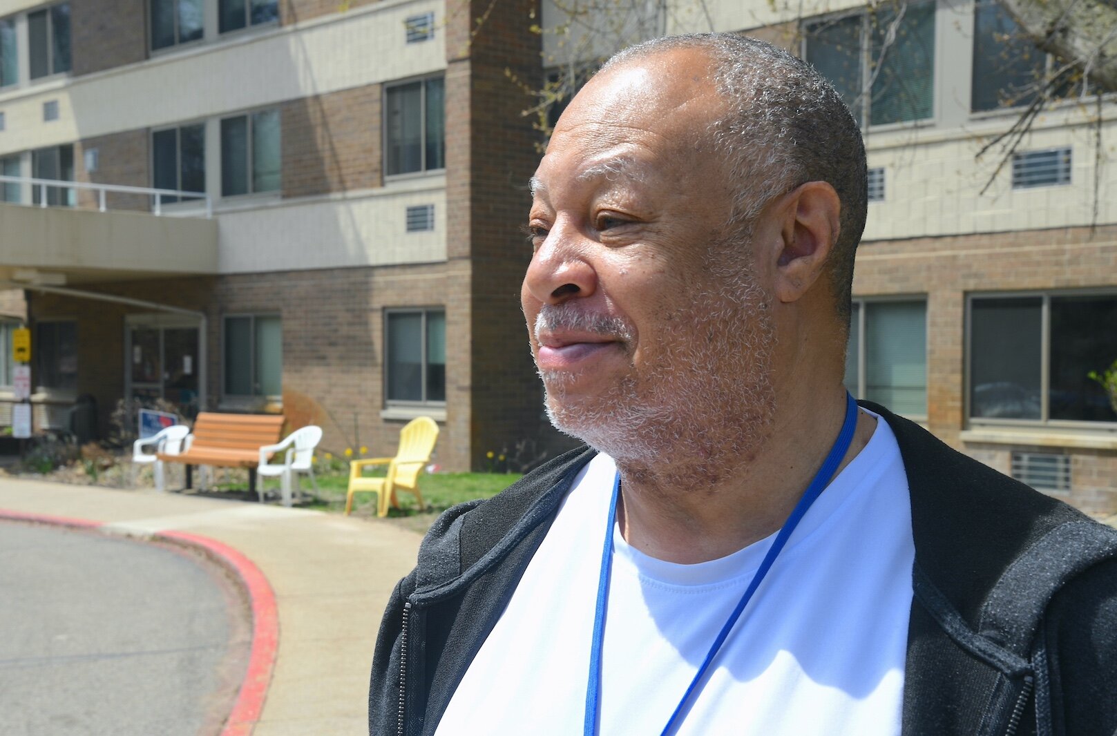 Lowell Wilson stands outside the Springview Tower apartment complex.