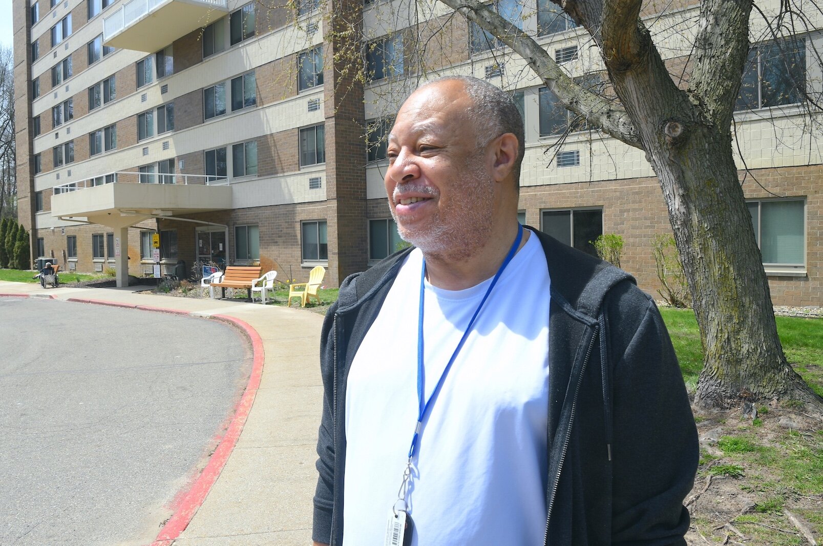 Lowell Wilson stands outside the Springview Tower apartment complex.