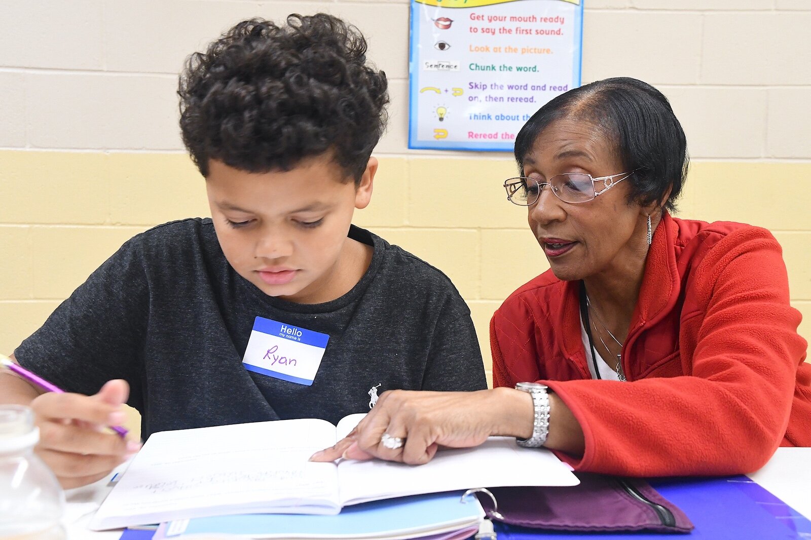 Roxie Perry, right, works wih Ryan Thompson, 10, at Second Missionary Baptist’s after- school tutoring program.