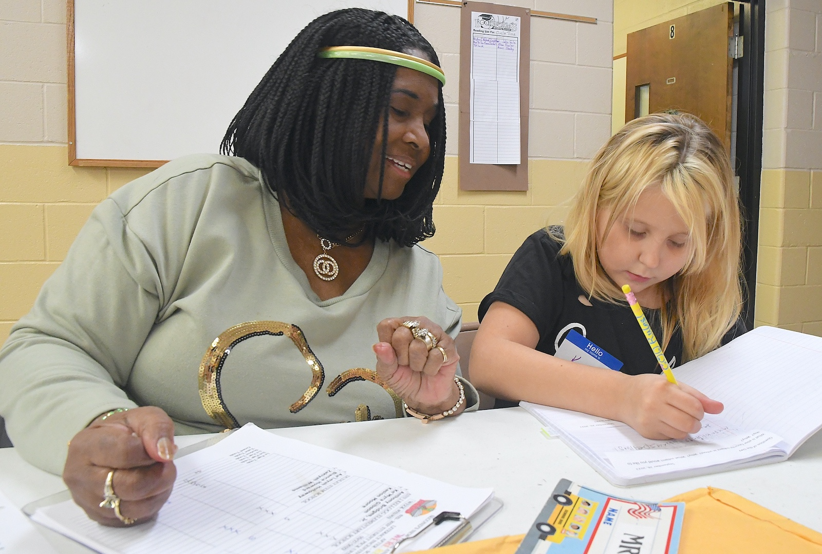 Deboraha Sallee, left, works with Kora Spicer, 8, at Second Missionary Baptist’s after- school tutoring program.