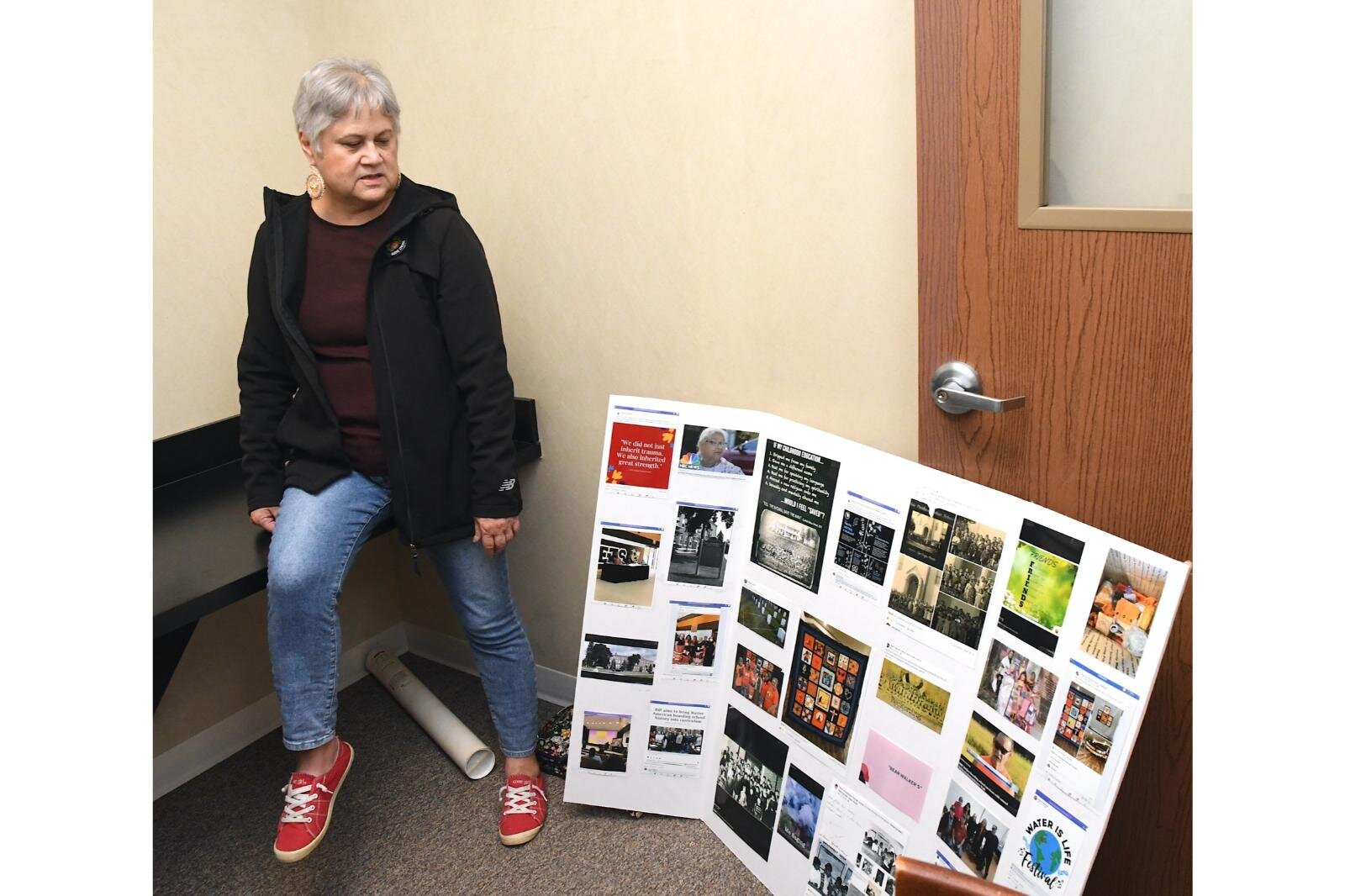 Sharon Skutt, who was a student at Holy Childhood School of Jesus in Harbor Springs, stands next to a memory board she made.