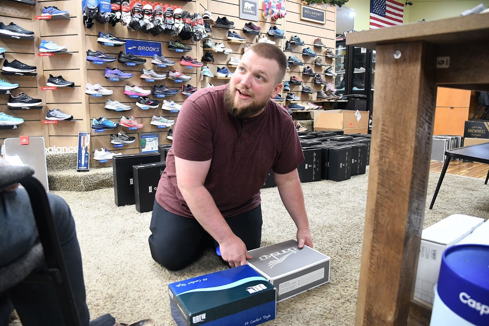 Lance Graham talks with a customer at Rice’s Shoes at 62 W. Michigan in downtown Battle Creek.
