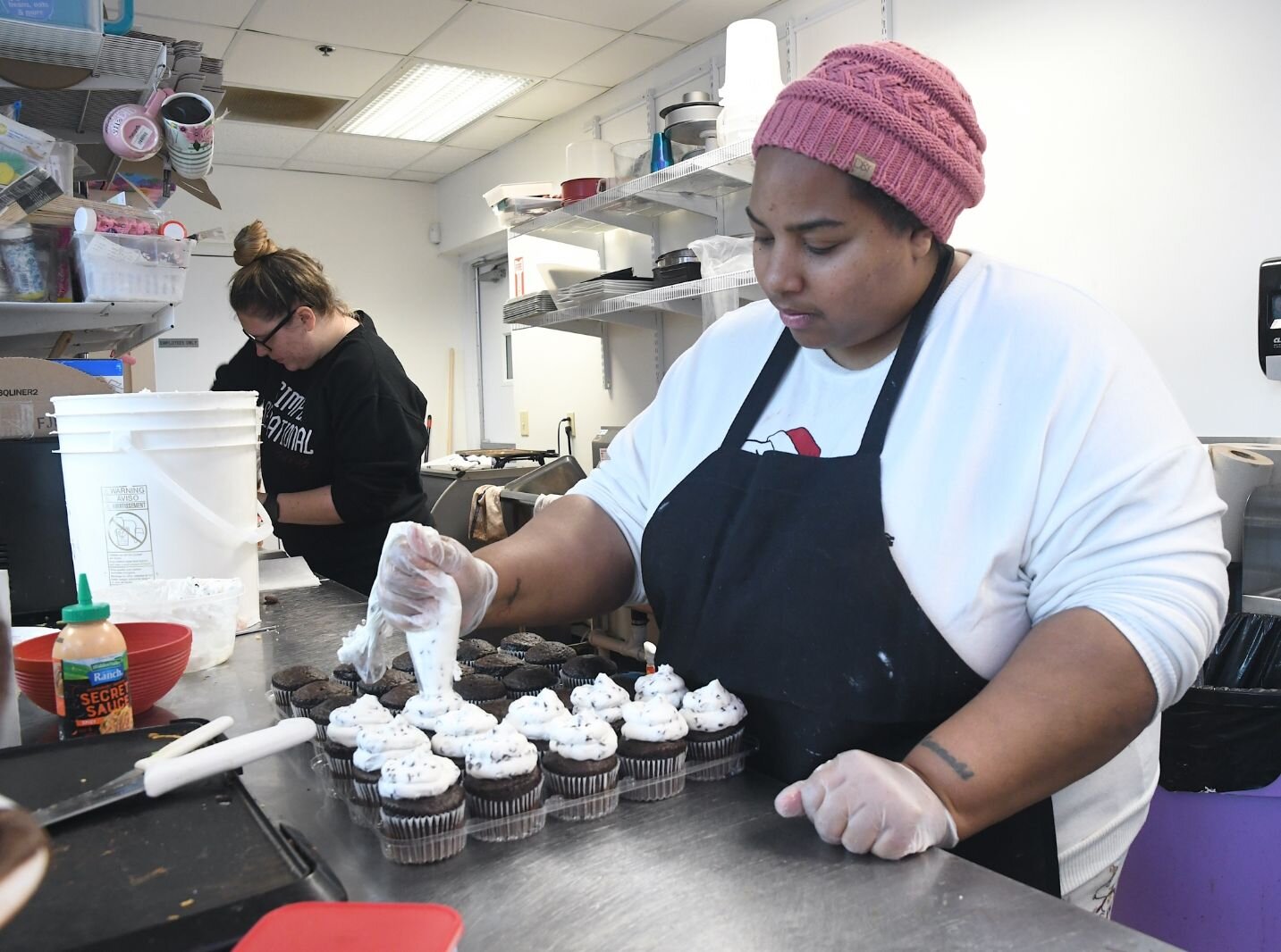 Markeeta Palmer, owner of Simply Sensational, 80 W. Michigan in downtown Battle Creek, decorates a pastry.