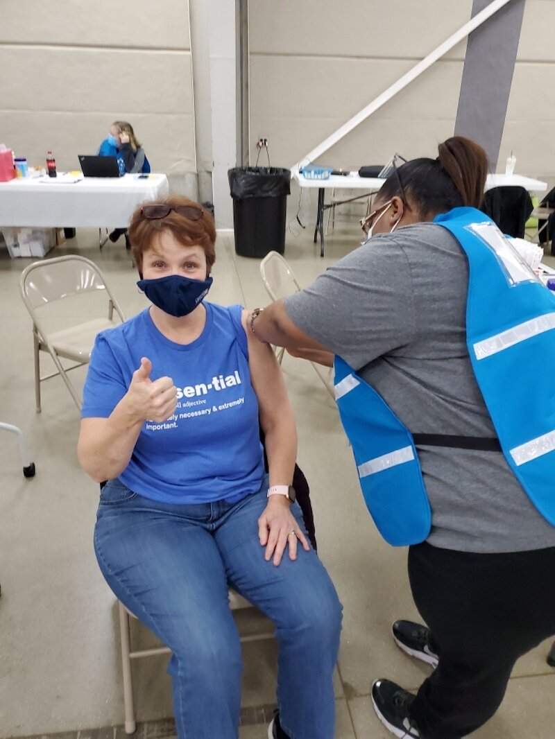 Karla Fales receives a COVID-19 vaccine.