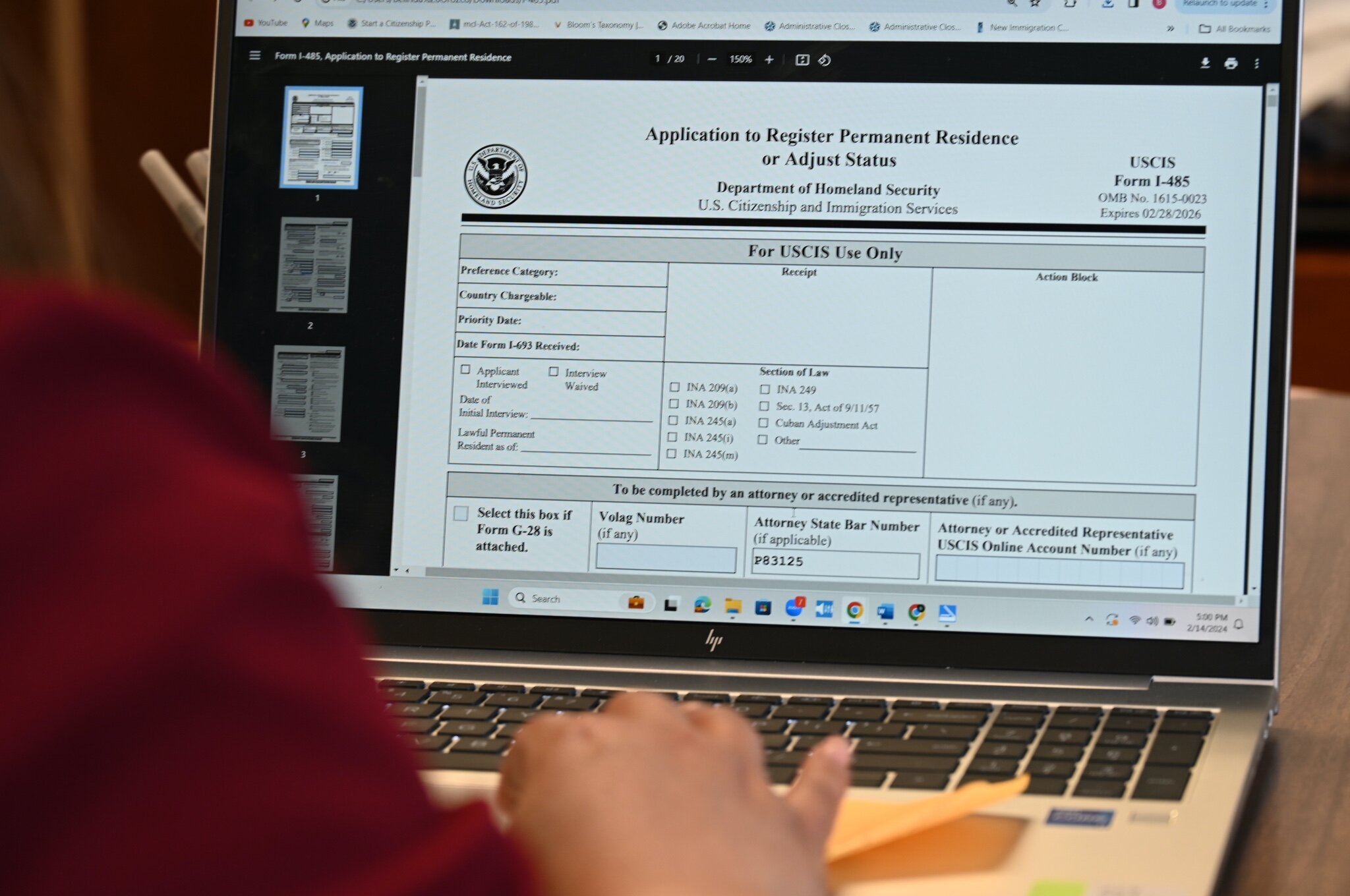 Belinda M. Orozco, Esq. looks at immigration forms from the U.S. Citizenship and Immigration Services website.