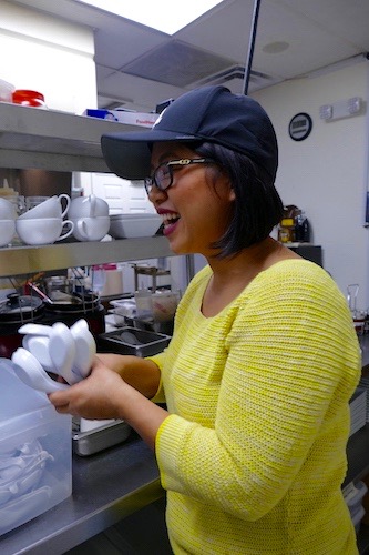 Jennifer Cole's sister , Amanda Sunthang, holding clean soup spoons. 