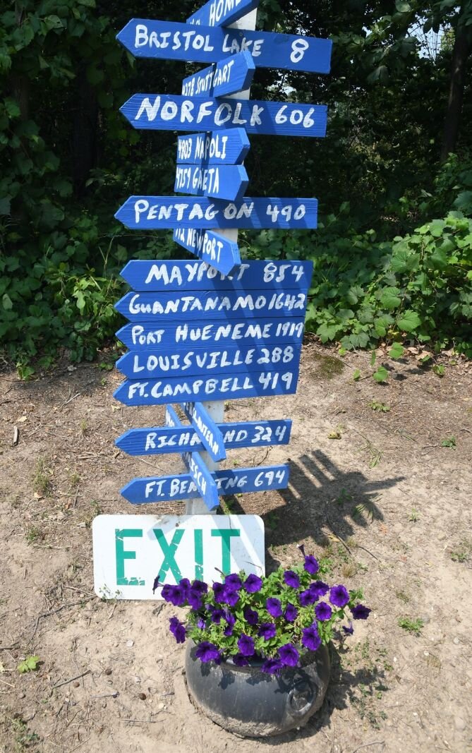 Sign near the entrance to Paint Pony Haven showing posts where Corky Malcom served in the U.S. Navy.