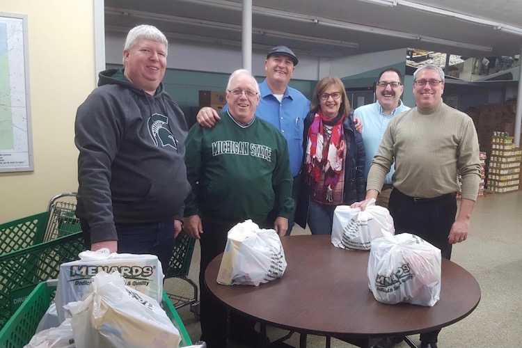 Some of the members of the Cereal City Sunrise Rotary Club who recently worked on packing food backpacks at the Love Thy Neighbor Food Pantry.