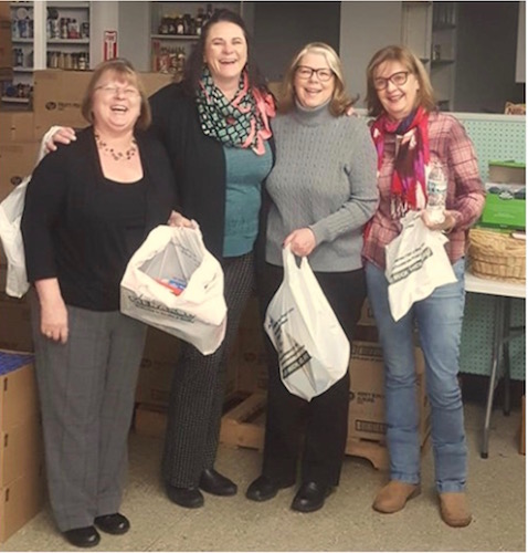 Some of the members of the Cereal City Sunrise Rotary Club who recently worked on packing food backpacks at the Love Thy Neighbor Food Pantry.