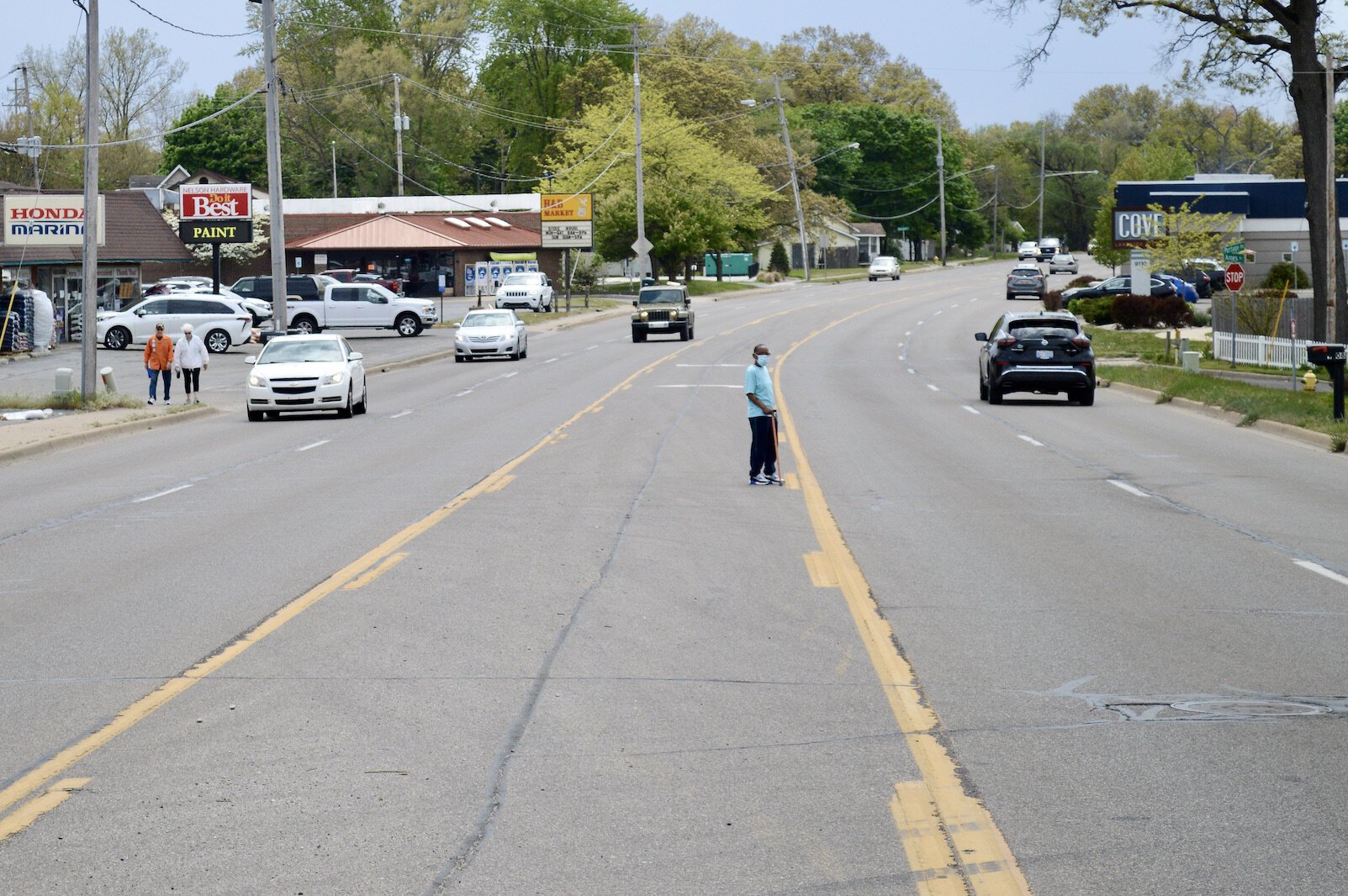 Transportation plans take into account all kinds of needs such as those of pedestrians. A pedestrian attempts to cross Portage Road near West Lake. 