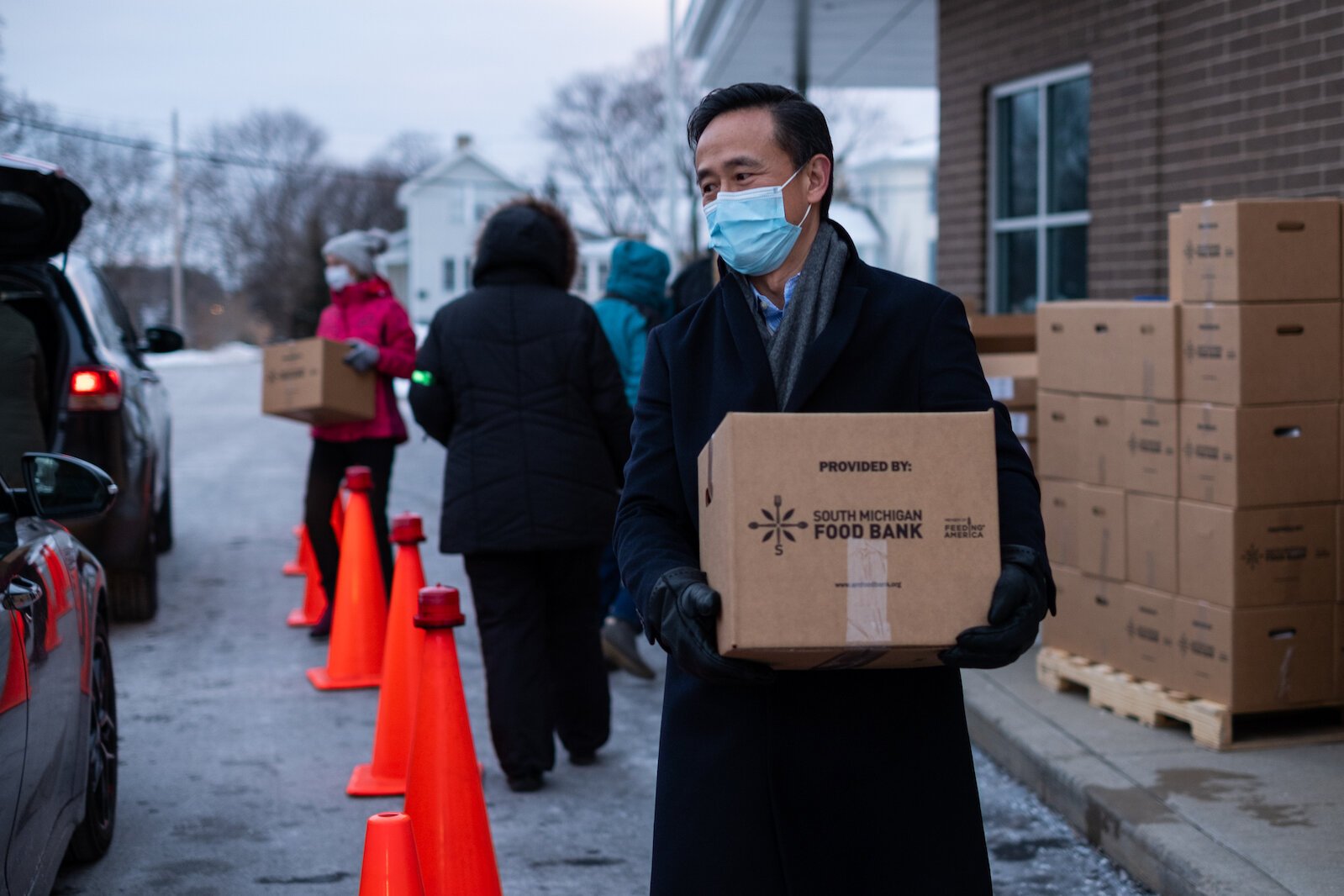 Peter Chang CEO of Grace Health, helps distribute boxes of fresh food to those participating in the Fresh Food Pharmacy program.