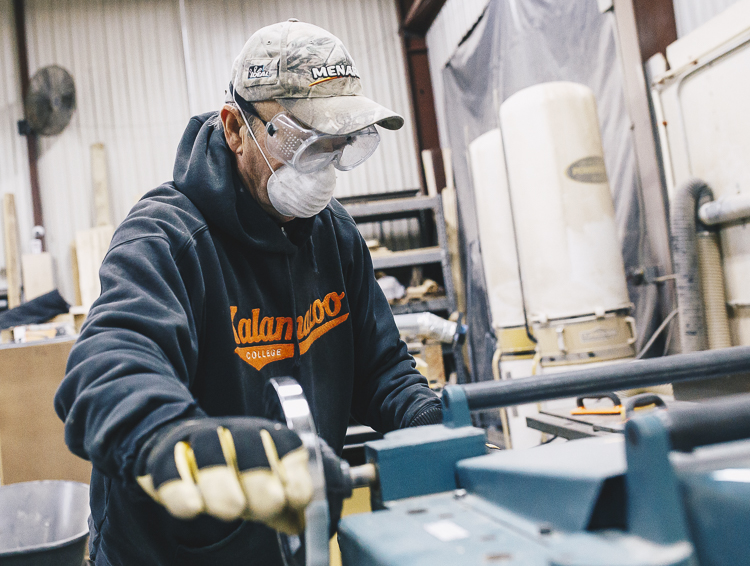 Kzoo Makers member Richard Kent runs a wood planer.