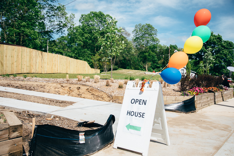 Balloons and signs welcomed visitors to the celebration of the Eastside Gatewau opem house/