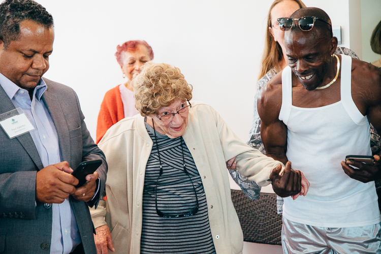 Gwen Tulk (center) attended the Eastside Open House and Celebration and was honored with a cake and song for turning 102. 