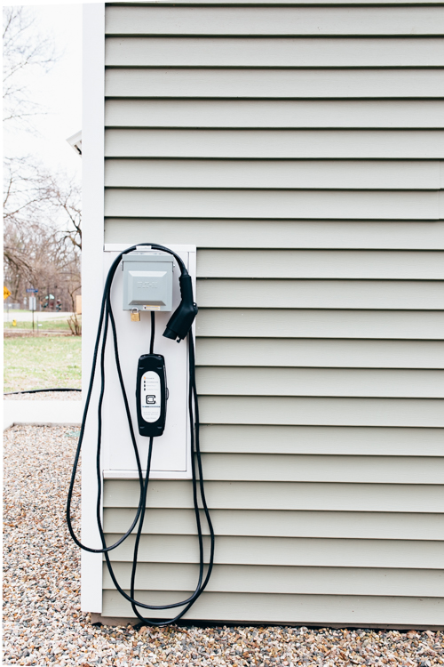 An outdoor charging port provides juice for Ben Brown's electric Mitsubishi ie MiEV.