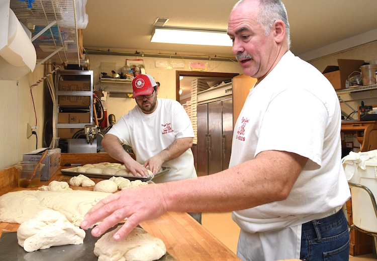 Tim Wygant, right, and his son Jordan, prepare pizza dough at Pizza Sam’s.
