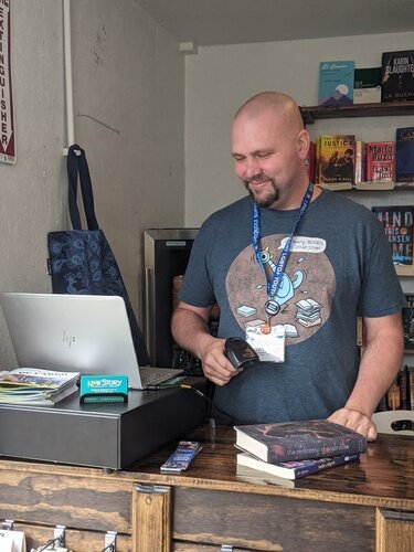 Tom Batterson is seen inside his cargo container store, New Story Community Books.  