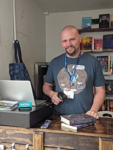 Tom Batterson is seen inside his cargo container store, New Story Community Books.  