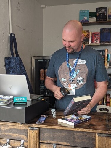 Tom Batterson is seen inside his cargo container store, New Story Community Books.  