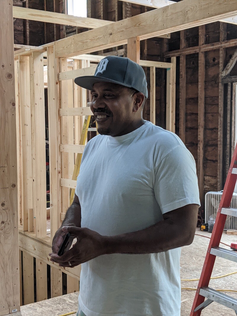  Raul Maysonet, founder and pastor of Hood Chucr, surveys the progress of heab work on Hope House.