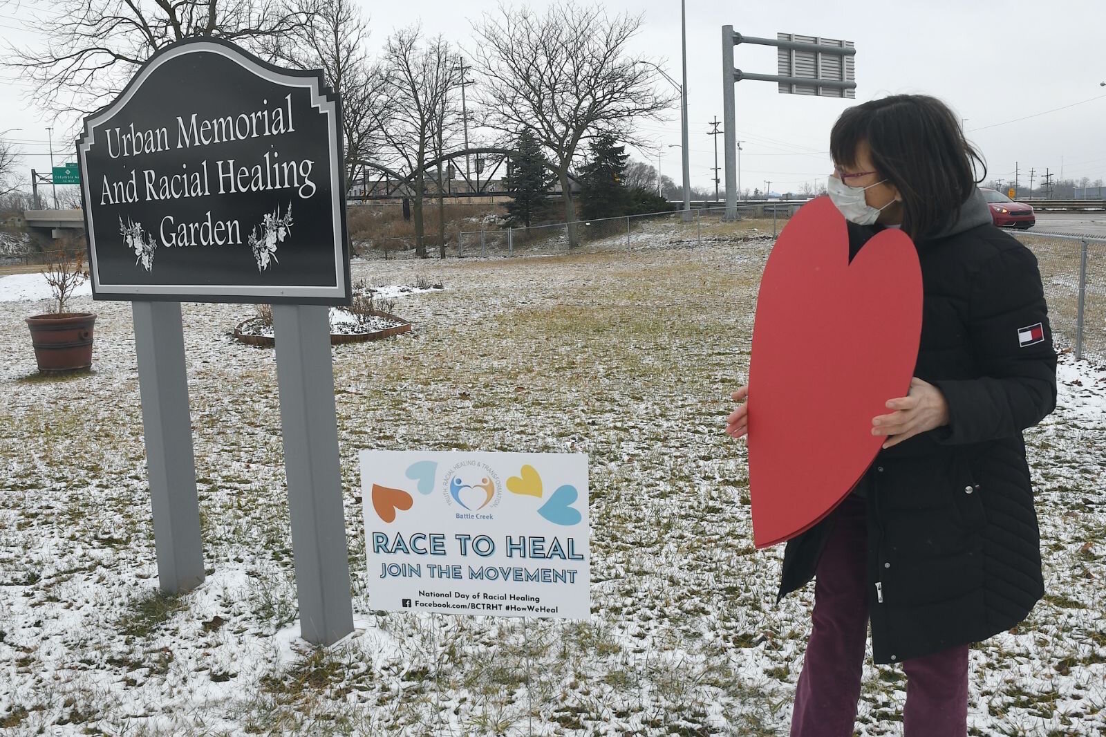 Kathy Antaya has finished putting up a racial healing sign by the Urban Memorial and Racial Healing Garden in downtown Battle Creek.