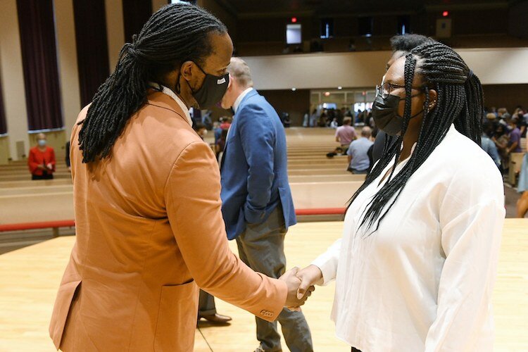 Ibram X. Kendi greets Akaiia Ridley, who joined him in a discussion of antiracism at Albion College. 
