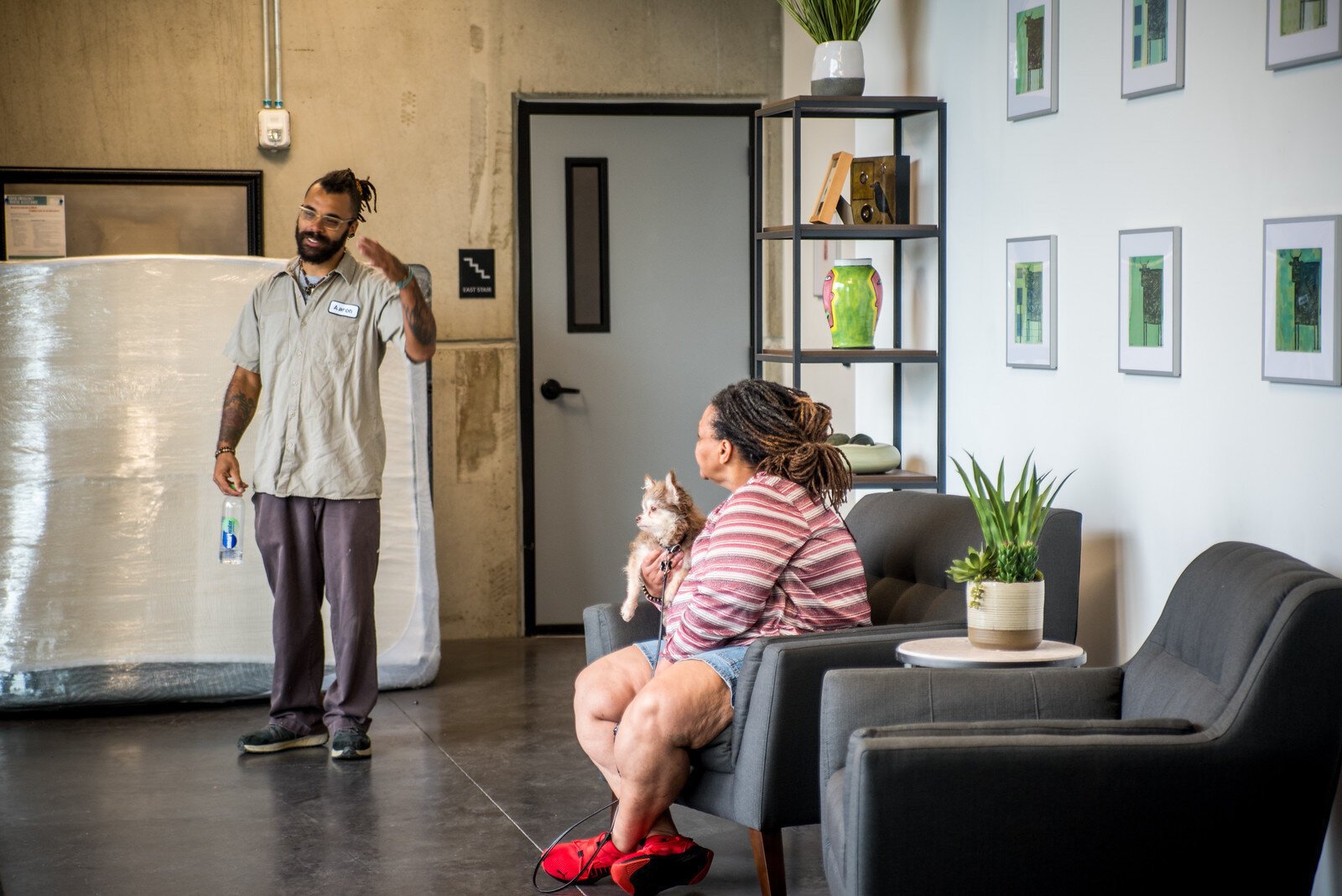 Two residents of Harrison Circle Apartments talk in the lobby of the new $18 million residential/commercial development.