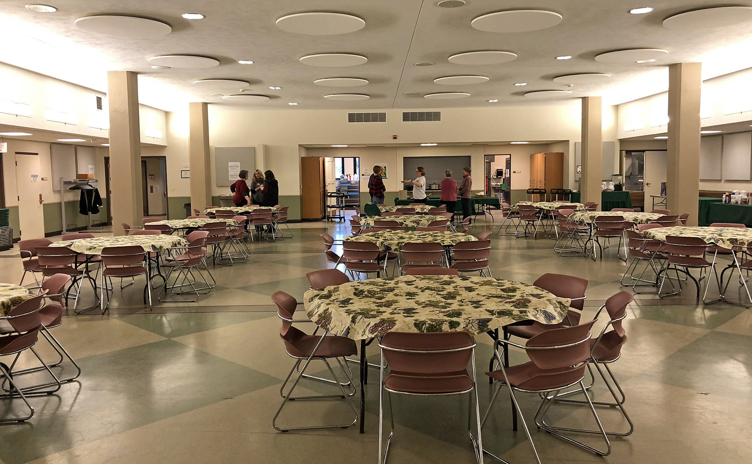 Volunteers wait in the dining room to welcome guests.