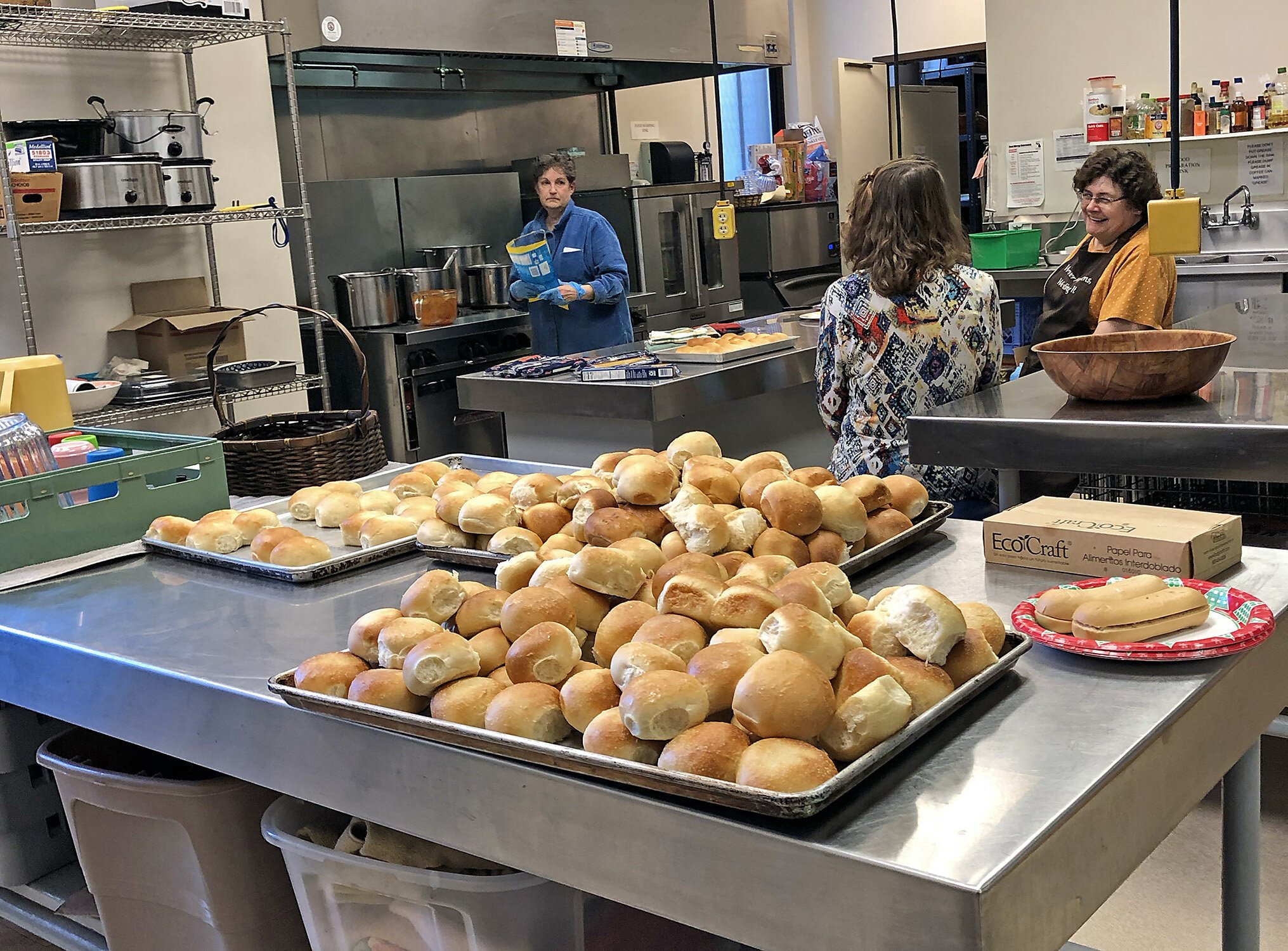 Volunteers prepare food in the kitchen of First Presbyterian Church.