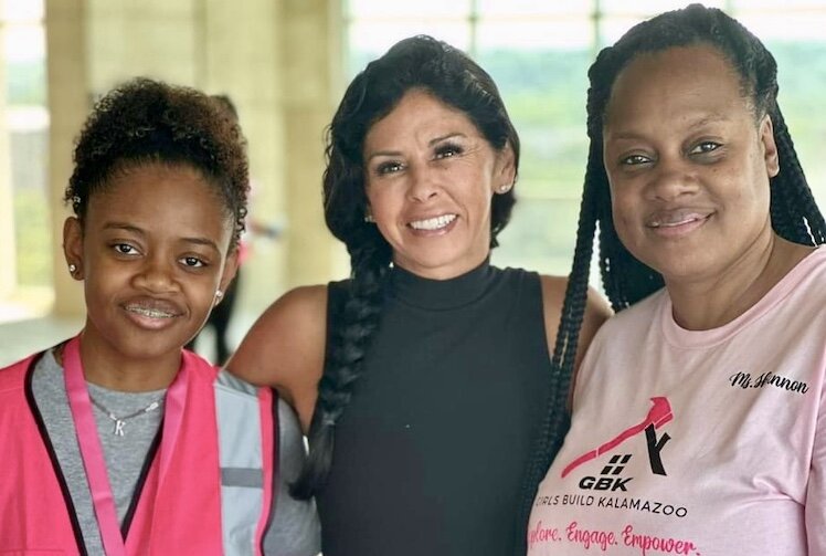 Angela Burkhardt, vice president of services for PlazaCorp Realty Advisors Inc., talks with Girls Build during a tour of the Exchange Building in downtown Kalamazoo.