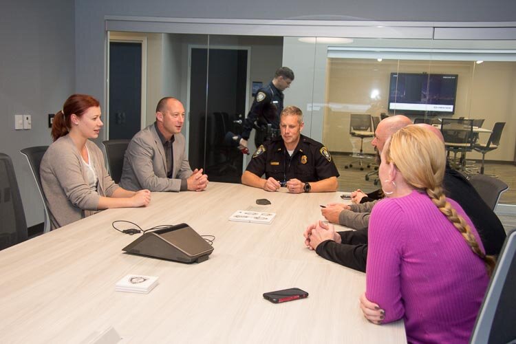 A group meets with Lt. Matthew Robinson, center. 
