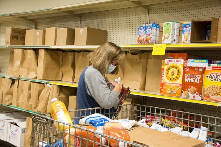 Volunteer Roxanne Frey helps get food donations ready for distribution.