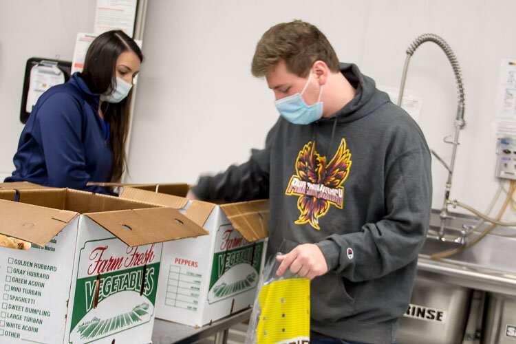 Volunteers help prepare food to be distributed to those in need. 