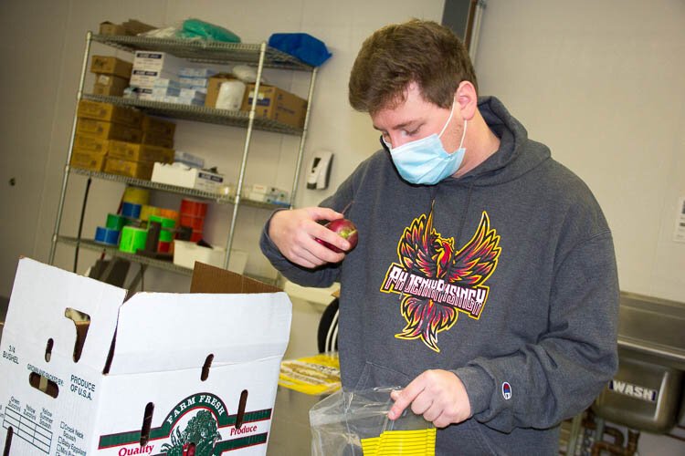 Volunteers help prepare food to be distributed to those in need. 