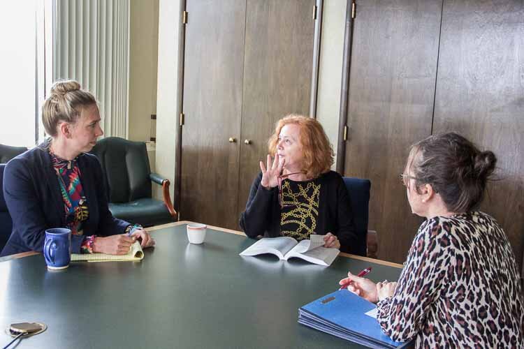 From left, Maggie Ruskin, Donna Innes, and Rachel Suhrbier. discuss a legal matter.