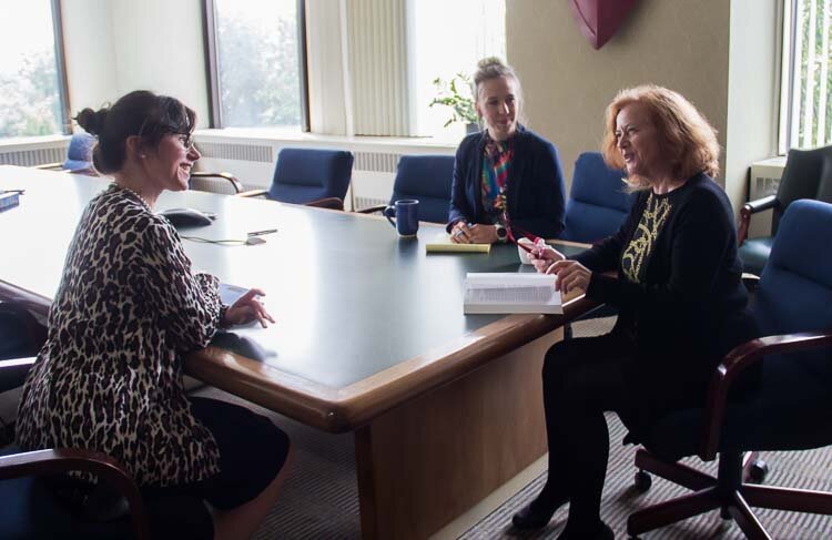From left, Rachel Suhrbier. Donna Innes, and Maggie Ruskin,  discuss a legal matter.