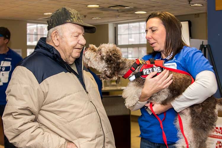 There were lots of human hugs and doggy kisses when volunteers in the Hug Ambassadors program recently offered hugs to veterans at the VA in Battle Creek.