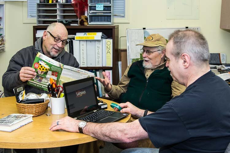 Al Rizzo at the Oakwood Community Center visits with David Nesius (center) and Ron Lawson II. They are computer tech volunteer that help residents with their computers.