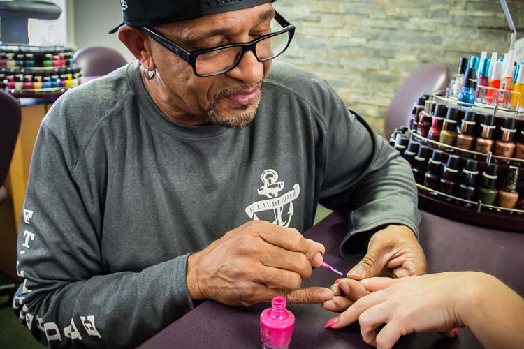 Ricky Thrash shows his nail polishing skills.