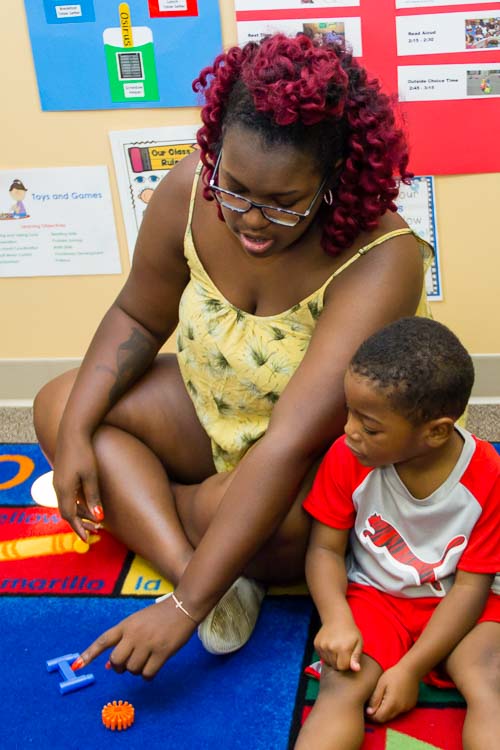 Aerin Caldwell, Assistant Teacher, works with preschoolers to get them ready for kindergarten.