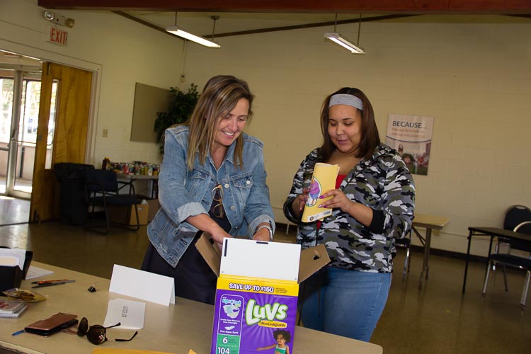Kathy Szenda Wilson and Aliyah work together at a recent diaper distribution.