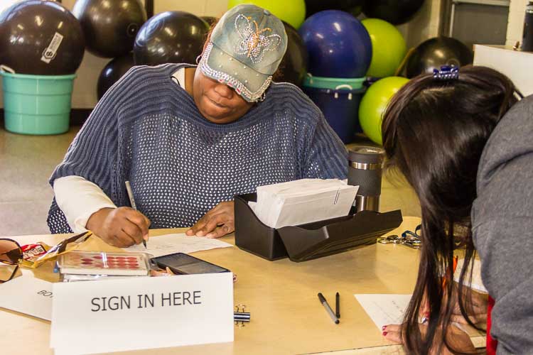 Denise Rucker helps sign in those seeking diapers or other available resources. 