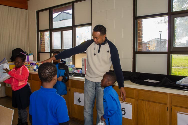 Dr. Michael Glass talks to the young helpers at a recent diaper distribution.