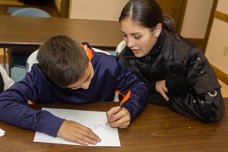 Students get assistance as they learn in the VOCES classroom