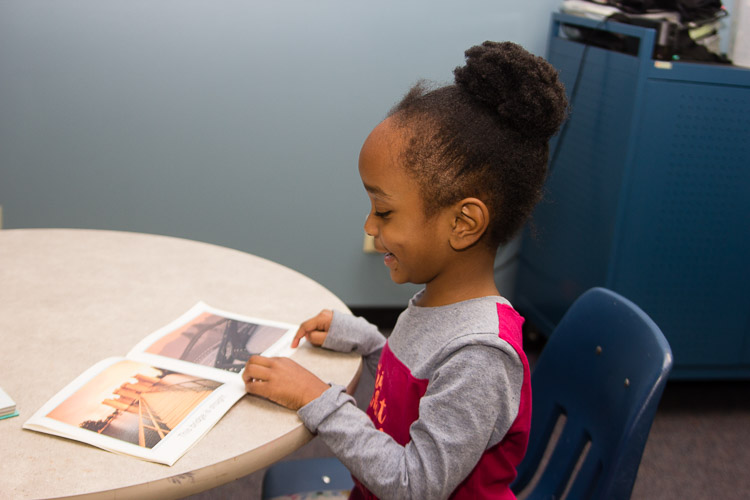 Youngsters enjoy their books at the New Genesis after-school program.