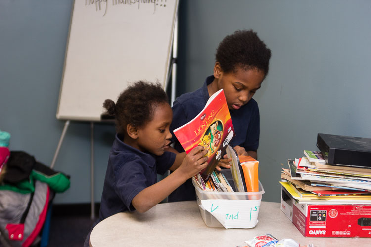 Youngsters enjoy their books at the New Genesis after-school program.