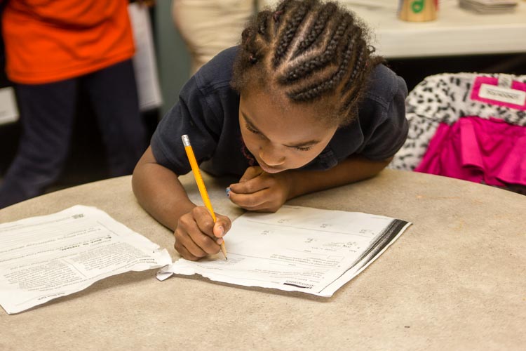 Youngsters' schoolwork is improving thanks to after school programs like the one at New Genesis