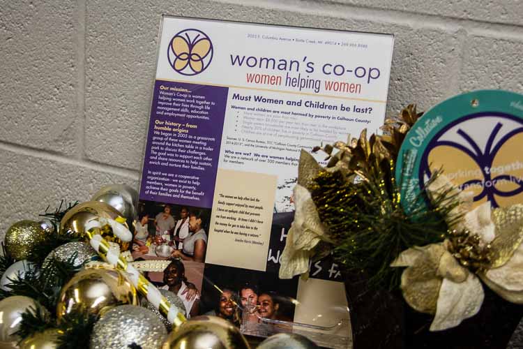 A sign in the "store" discusses the effects of poverty on women and children in Calhoun County.